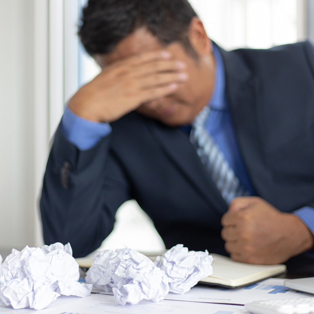 stressed man with crumpled paper