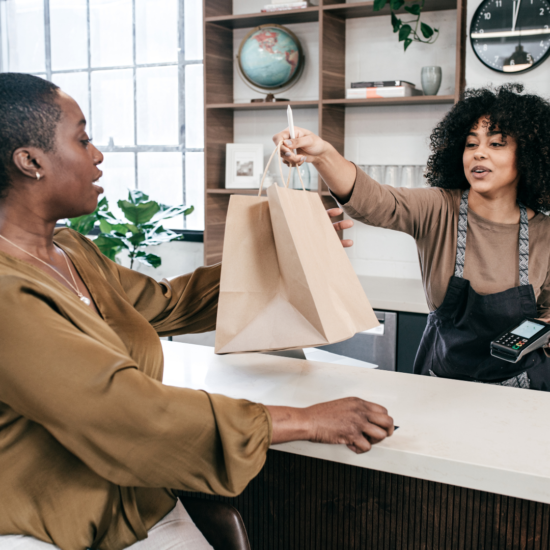 woman handing a bag