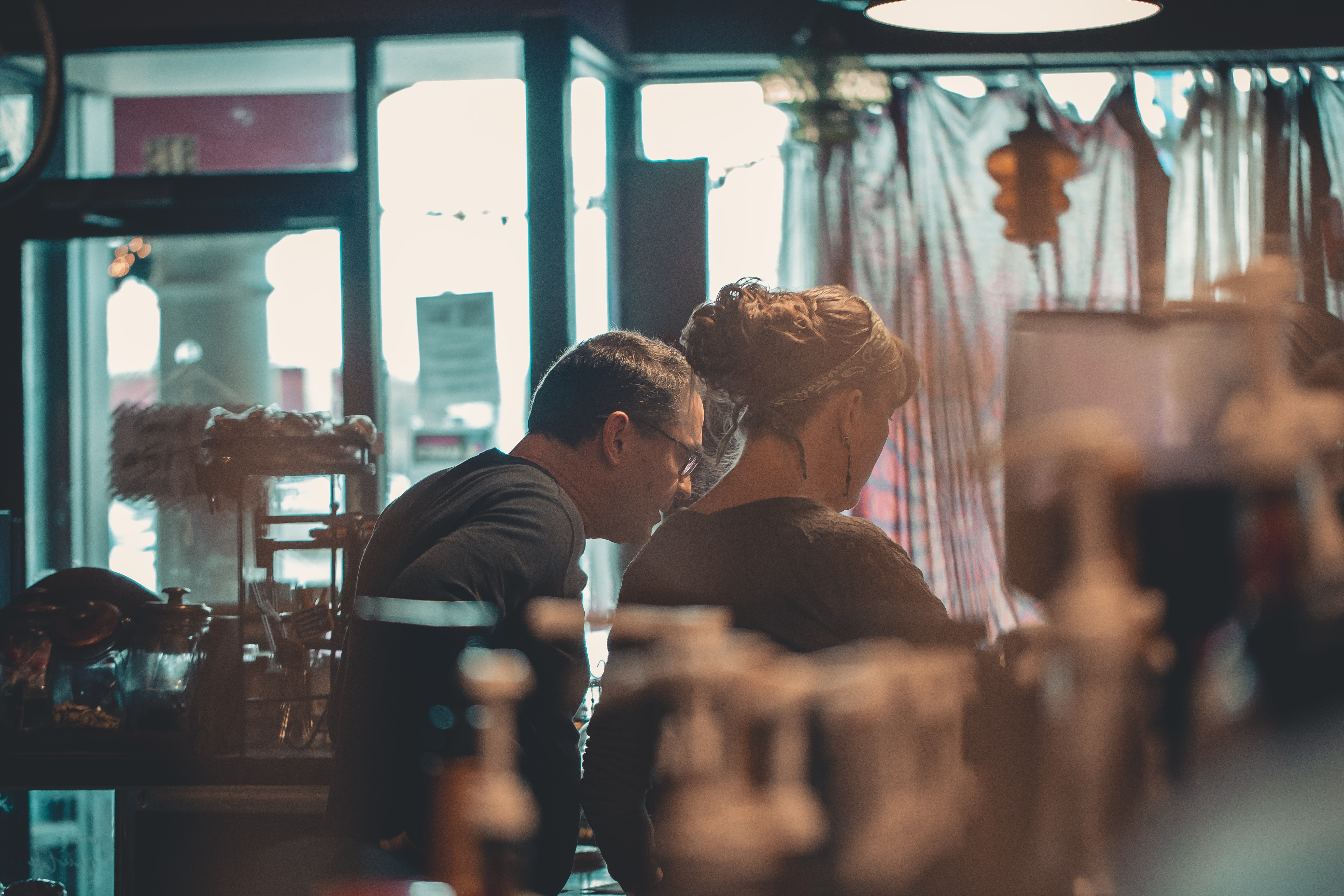 Two people looking through store window