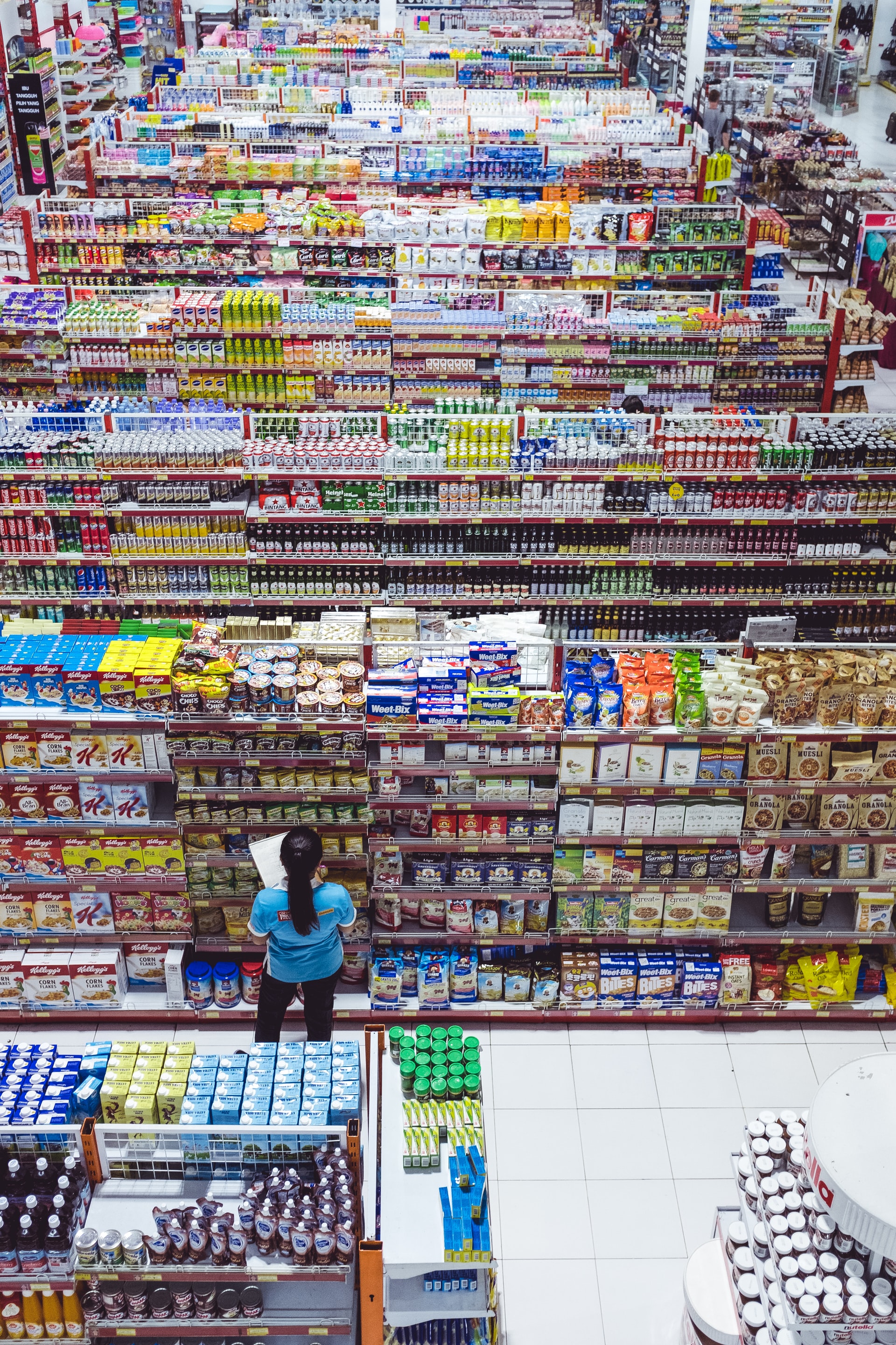 rows of filled shelves at supermarket