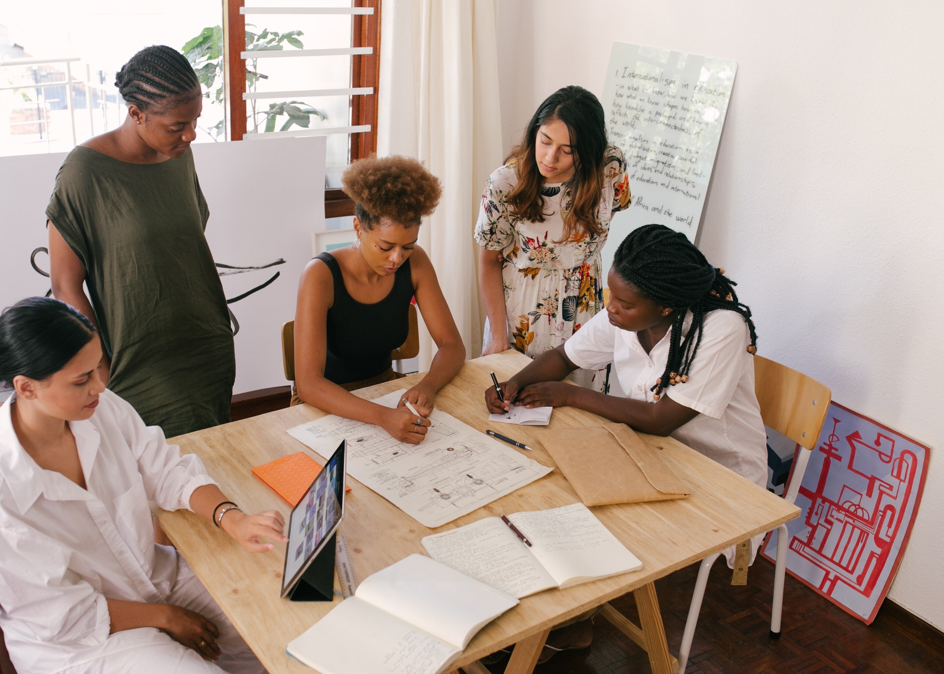 group of women working together around table