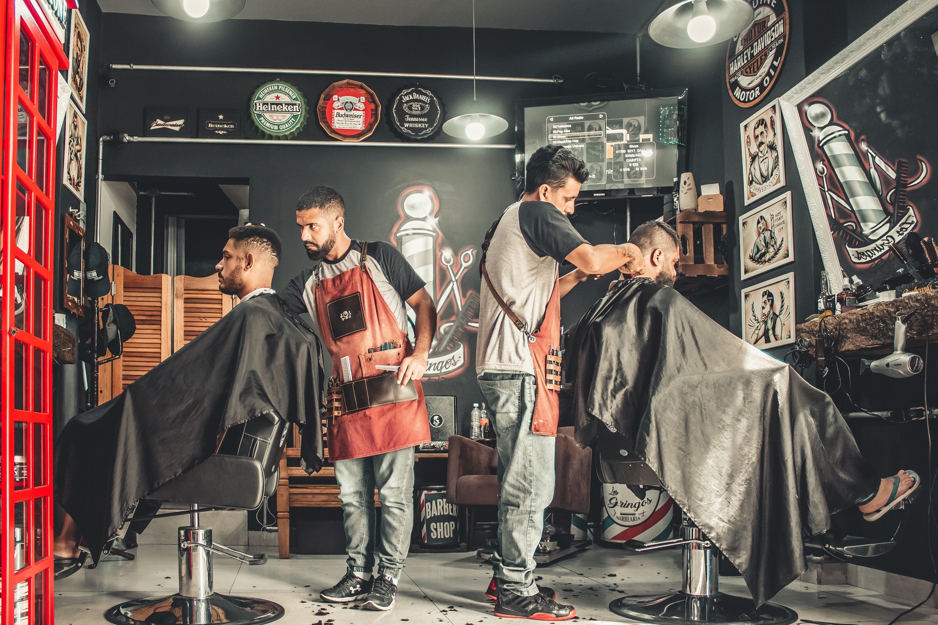 two men working in barber shop cutting hair