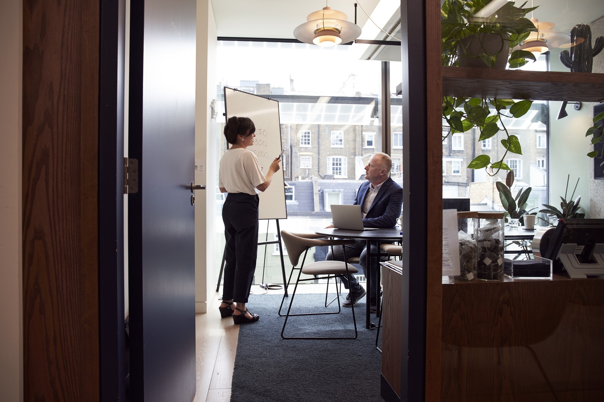 two people in meeting room discussing