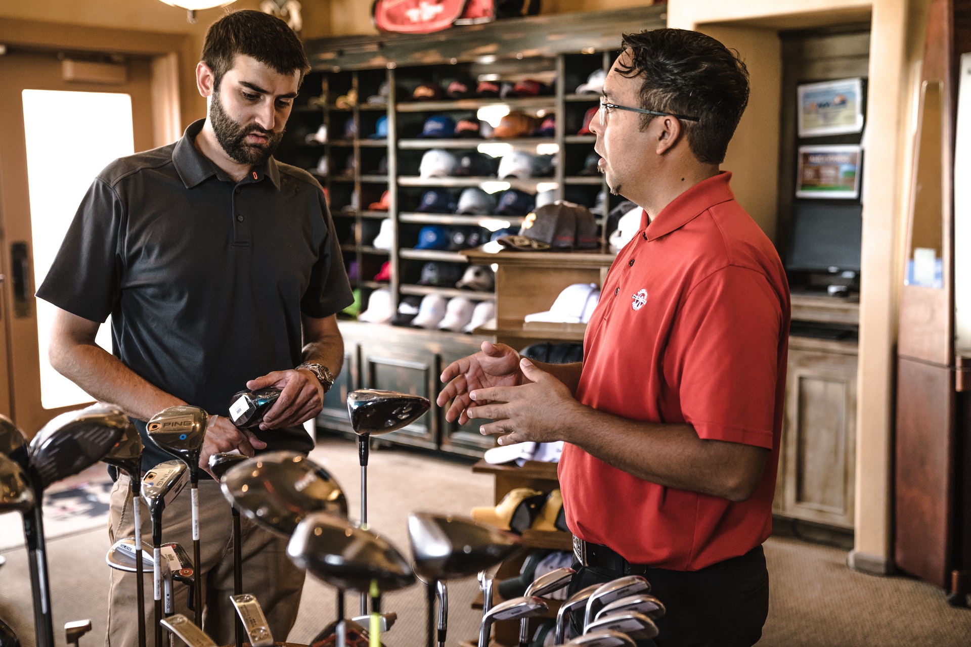 employer in golf shop talking to customer