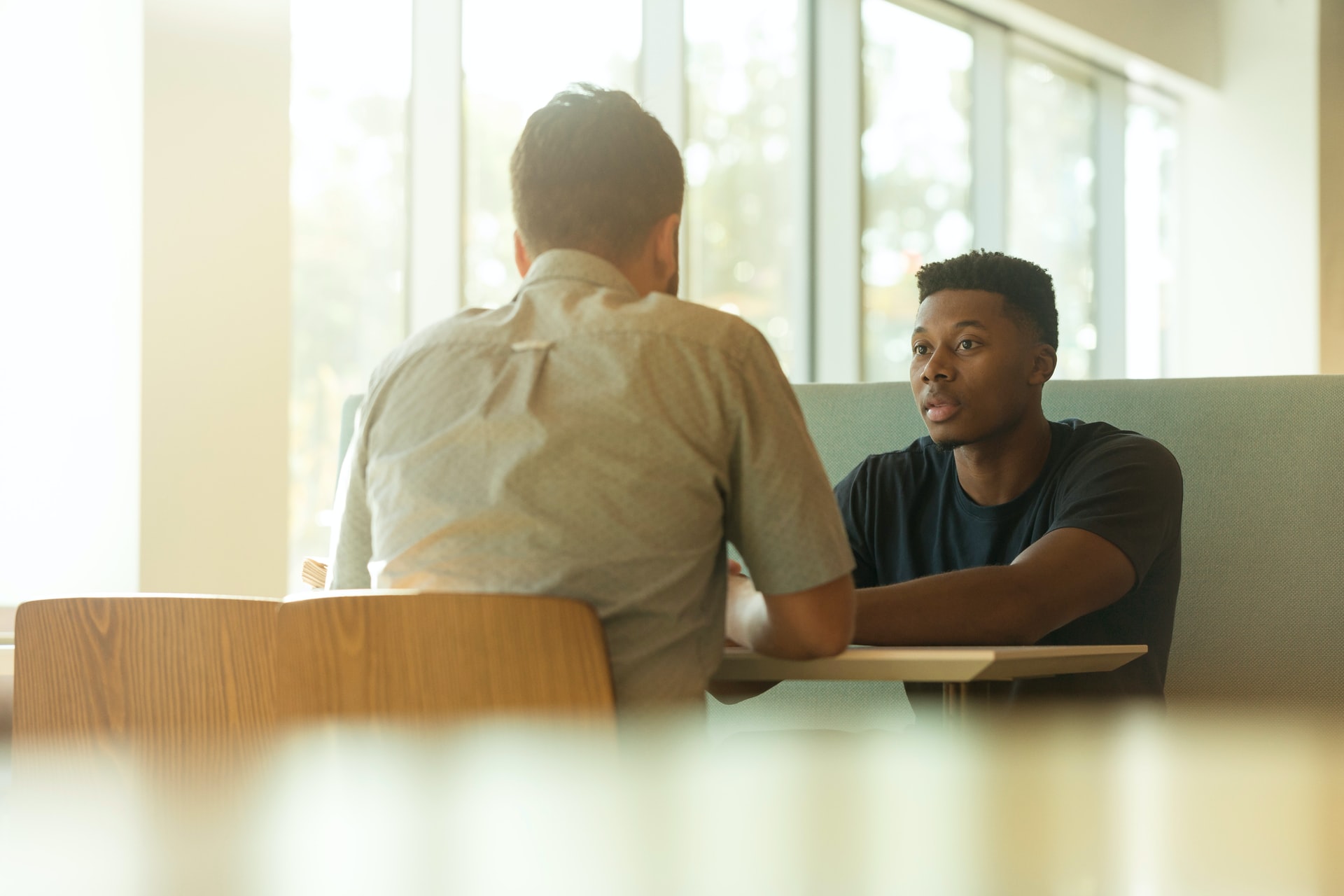 two men at table discussing