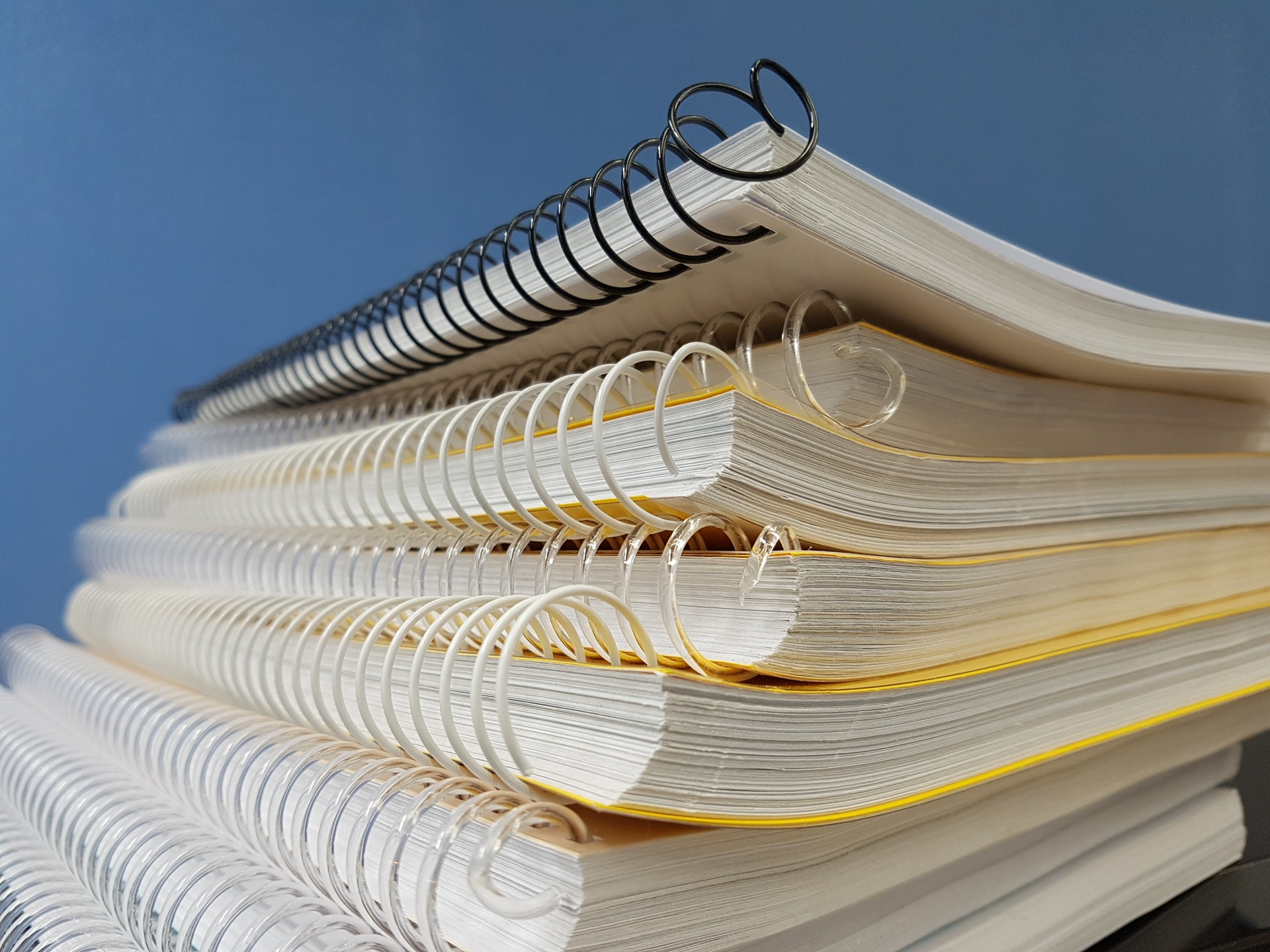 Stack of ringed notebooks with yellow covers